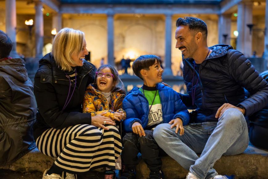 Family of 4 at the roman baths at night